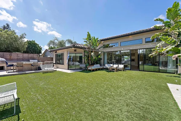 a view of a house with backyard porch and sitting area