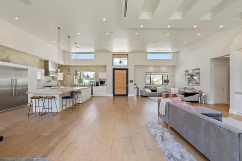 a living room with lots of furniture and kitchen view