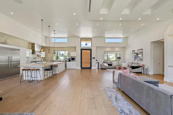 a living room with lots of furniture and kitchen view