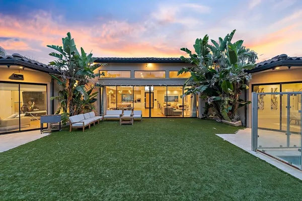 a view of a house with a backyard porch and sitting area