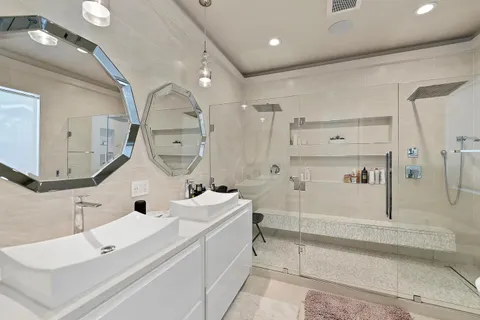 a bathroom with a sink a toilet and shower