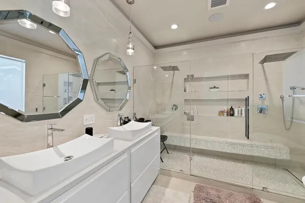 a bathroom with a sink a toilet and shower