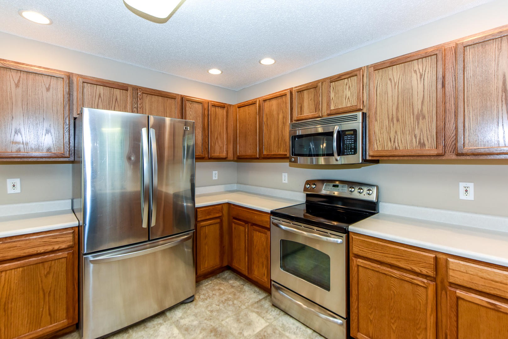 3605 Big Springs Ridge Road Friendsville, TN 37737 - Photo 11 of 32 a kitchen with stainless steel appliances granite countertop a refrigerator stove a sink dishwasher and microwave