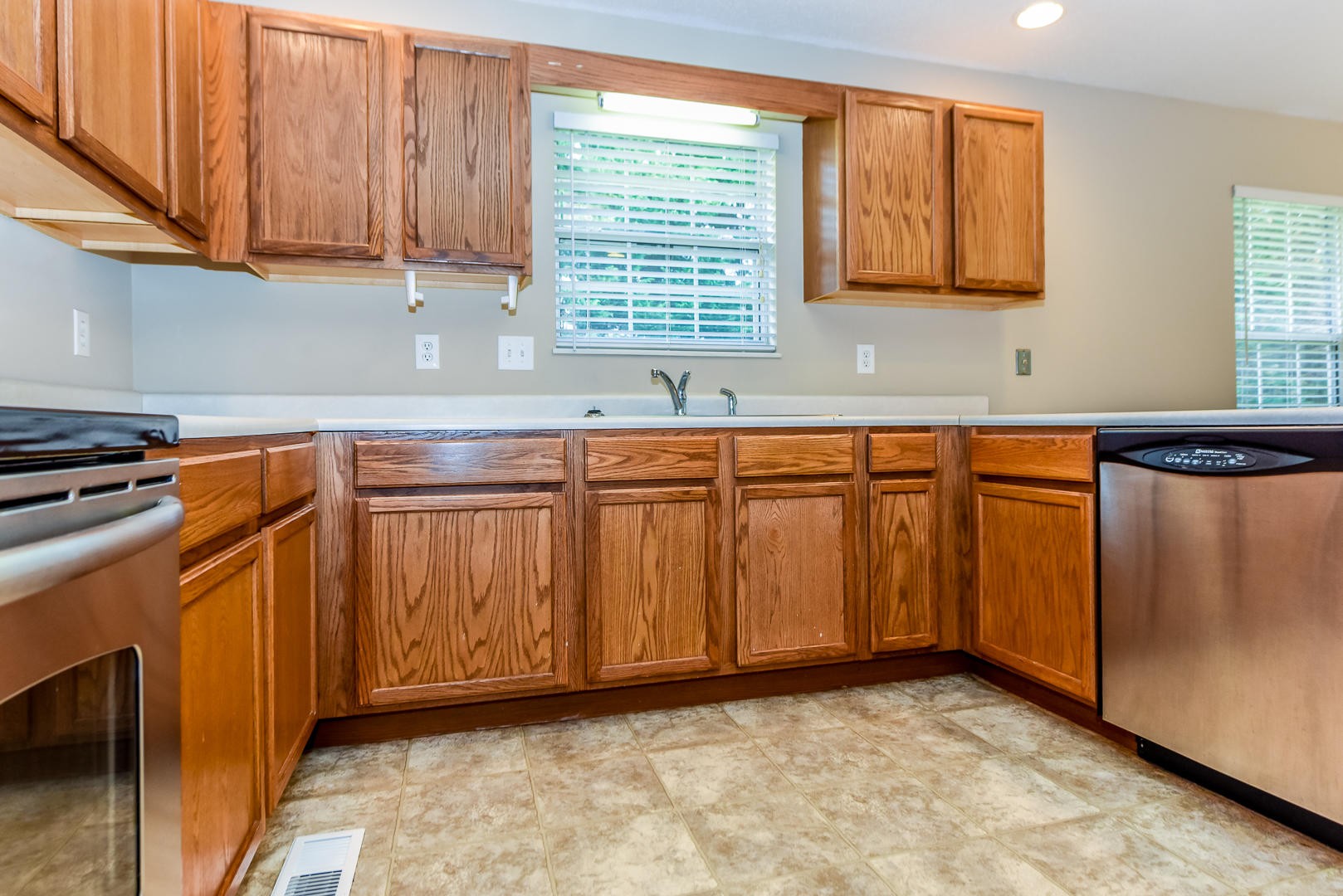 3605 Big Springs Ridge Road Friendsville, TN 37737 - Photo 13 of 32 a view of a kitchen with stainless steel appliances granite countertop wooden cabinets a sink and a window