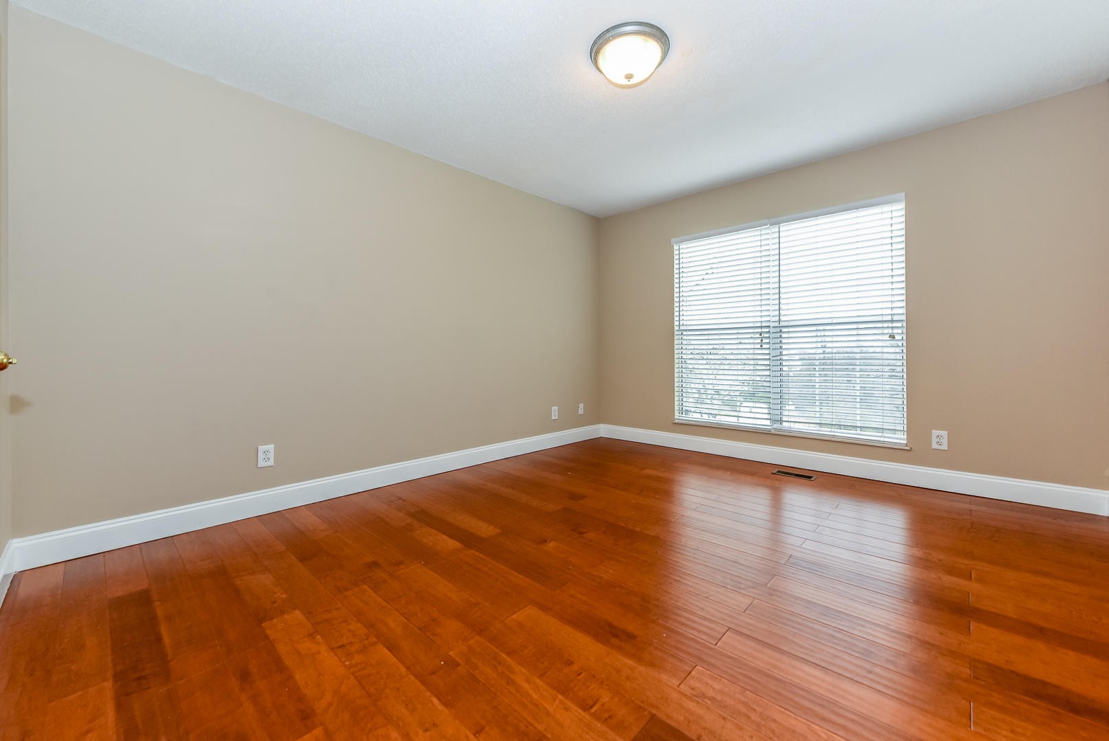 3605 Big Springs Ridge Road Friendsville, TN 37737 - Photo 21 of 32 an empty room with wooden floor and windows