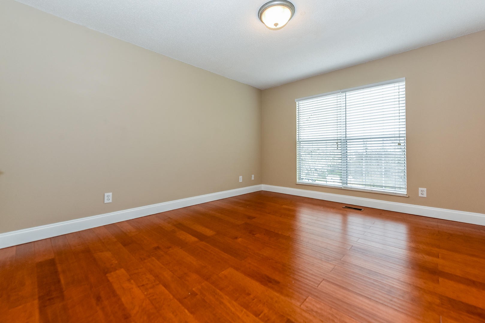 3605 Big Springs Ridge Road Friendsville, TN 37737 - Photo 22 of 32 a view of an empty room with wooden floor and a window