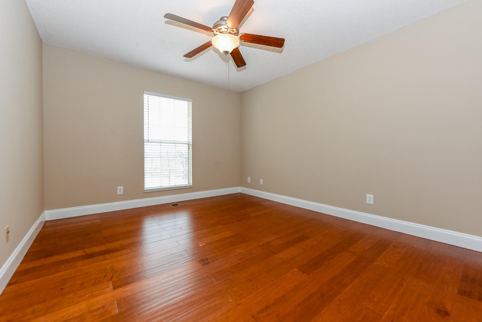 3605 Big Springs Ridge Road Friendsville, TN 37737 - Photo 26 of 32 an empty room with wooden floor and windows