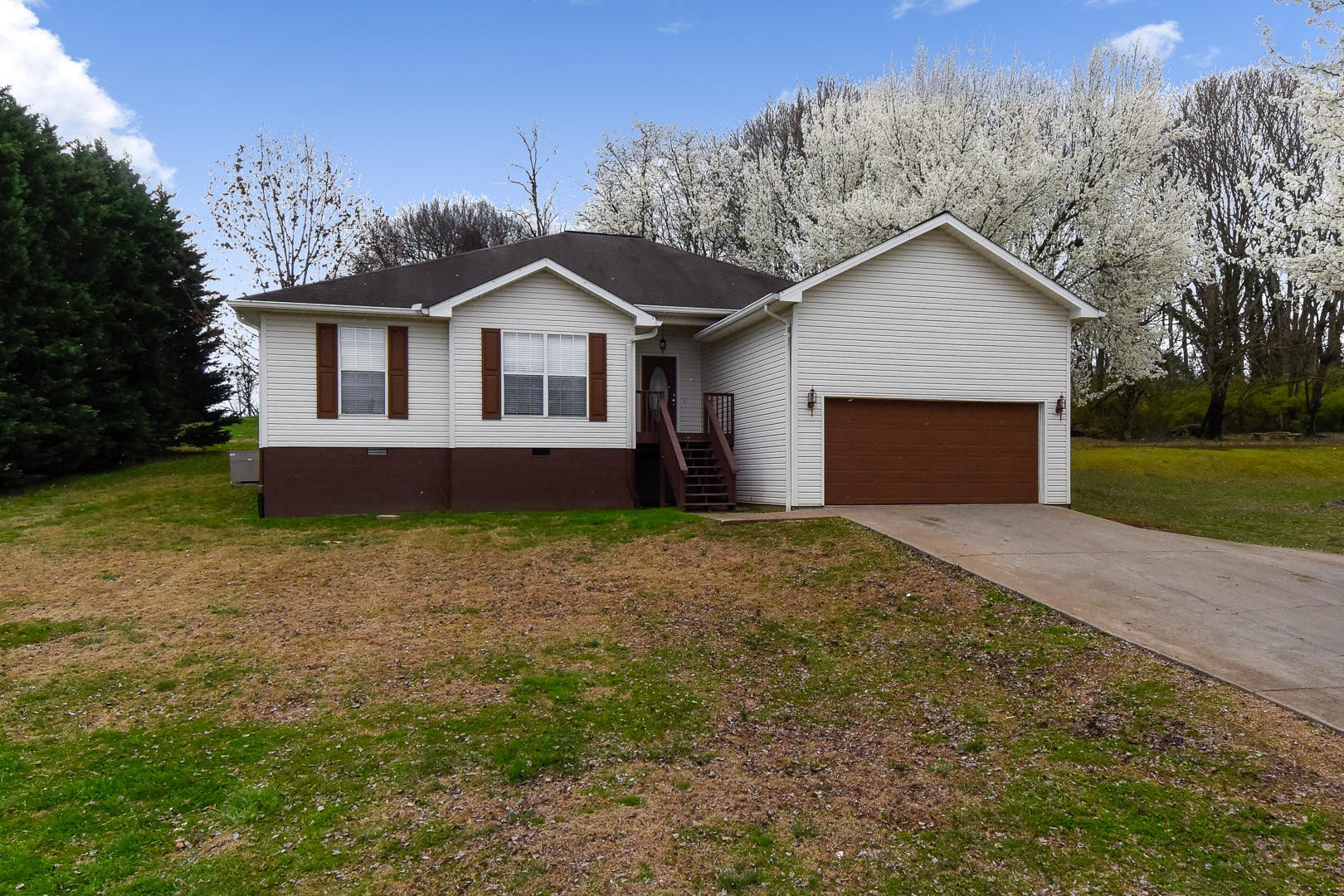 3605 Big Springs Ridge Road Friendsville, TN 37737 - Photo 32 of 32 a front view of a house with a yard and garage