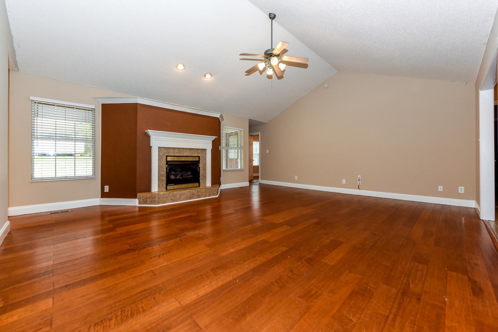 3605 Big Springs Ridge Road Friendsville, TN 37737 - Photo 5 of 32 an empty room with wooden floor fireplace and chandelier