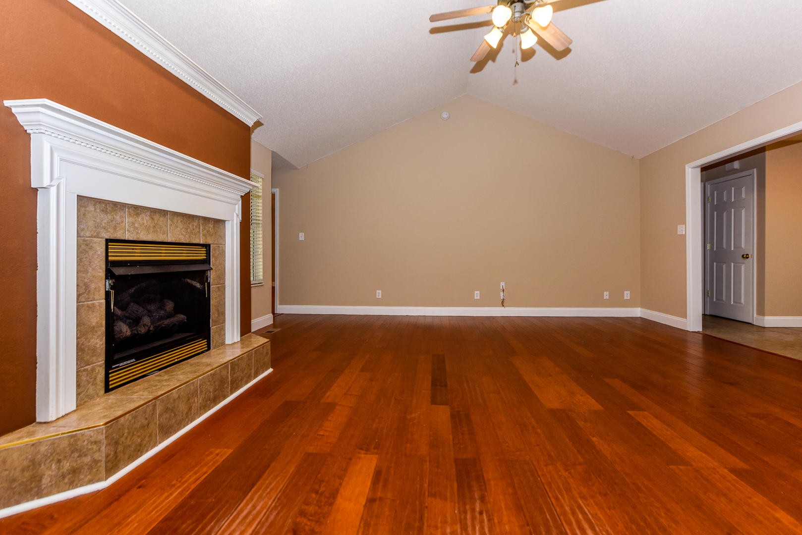 3605 Big Springs Ridge Road Friendsville, TN 37737 - Photo 6 of 32 a view of an empty room with wooden floor fireplace and a window