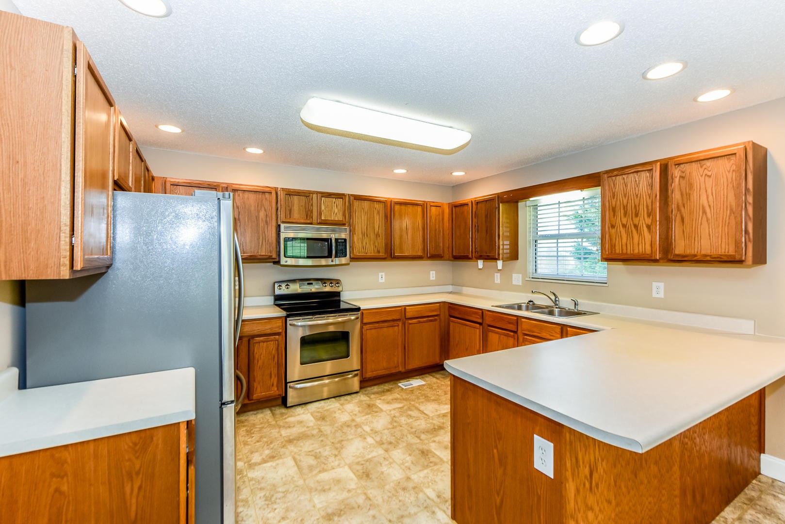 3605 Big Springs Ridge Road Friendsville, TN 37737 - Photo 8 of 32 a kitchen with a sink a stove a refrigerator cabinets and a counter top space