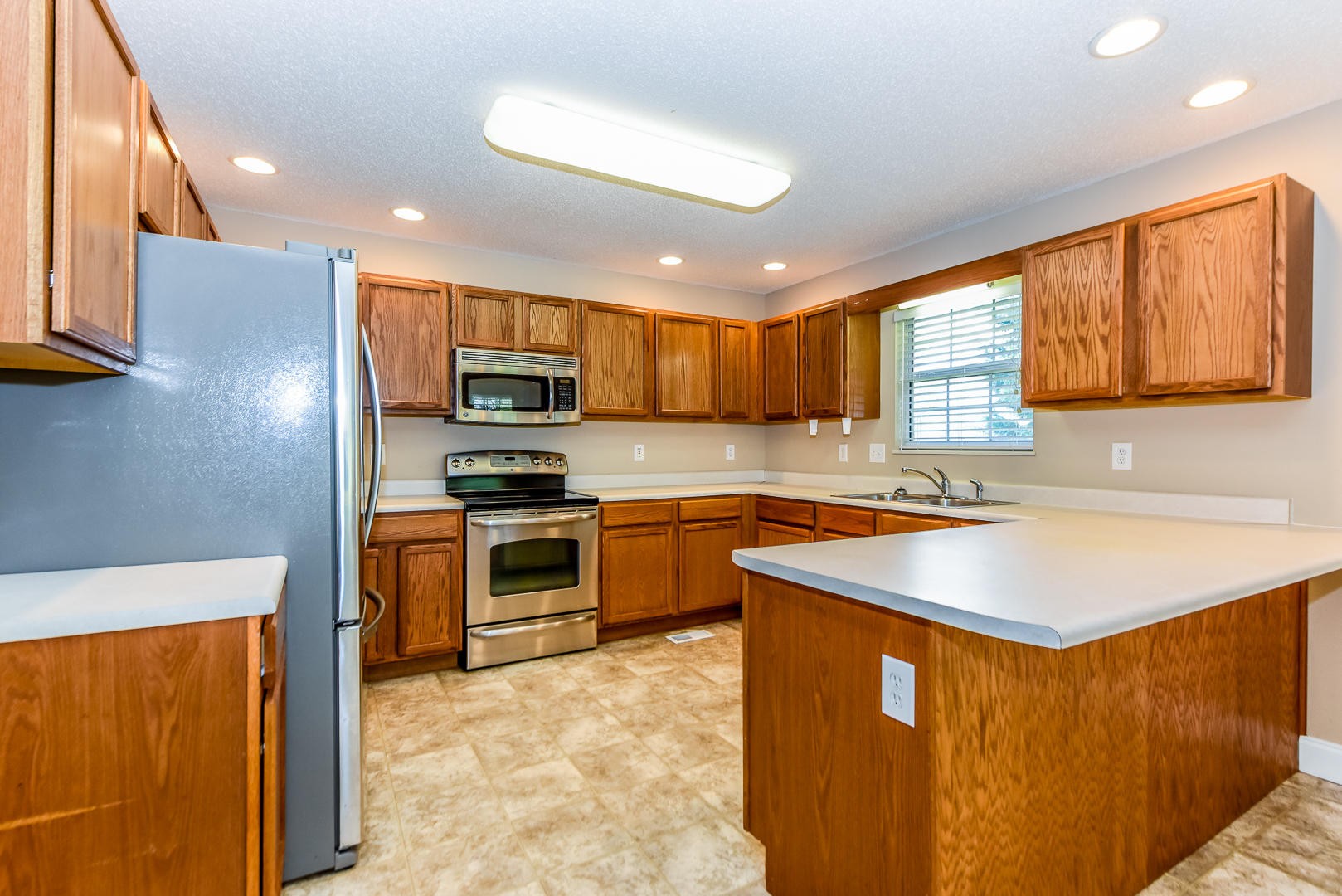 3605 Big Springs Ridge Road Friendsville, TN 37737 - Photo 9 of 32 a kitchen with stainless steel appliances granite countertop a sink stove and refrigerator