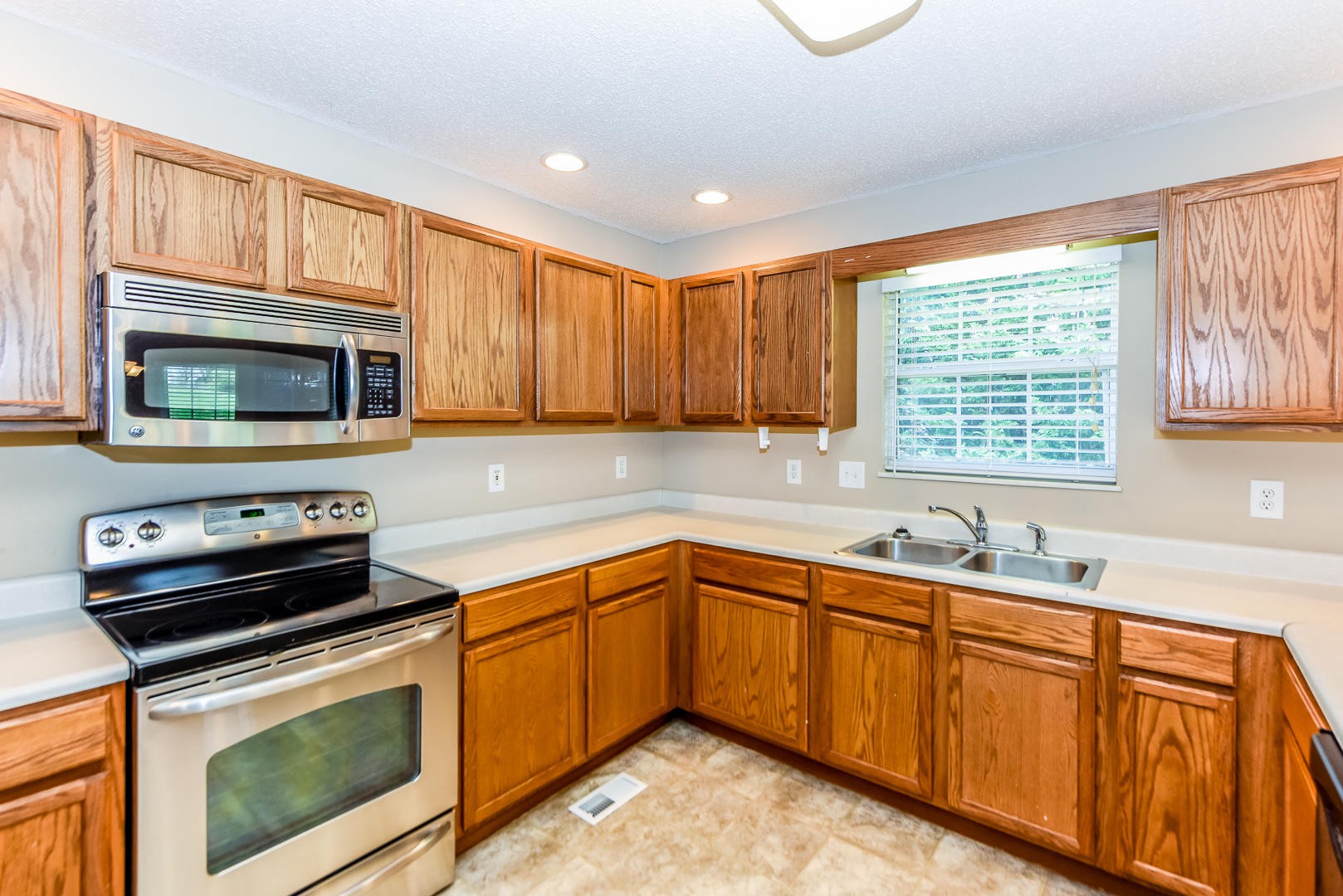 3605 Big Springs Ridge Road Friendsville, TN 37737 - Photo 10 of 32 a kitchen with stainless steel appliances a stove sink microwave and cabinets