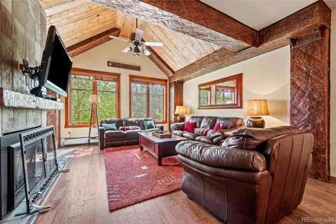 a living room with furniture a fireplace and a flat screen tv