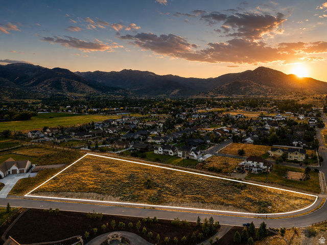 574 South Fox Den Road, Unit 3 Midway, UT 84049 - Photo 2 of 45 Expansive residential lot outlined, featuring natural ground cover, a paved street frontage, and surrounding established homes