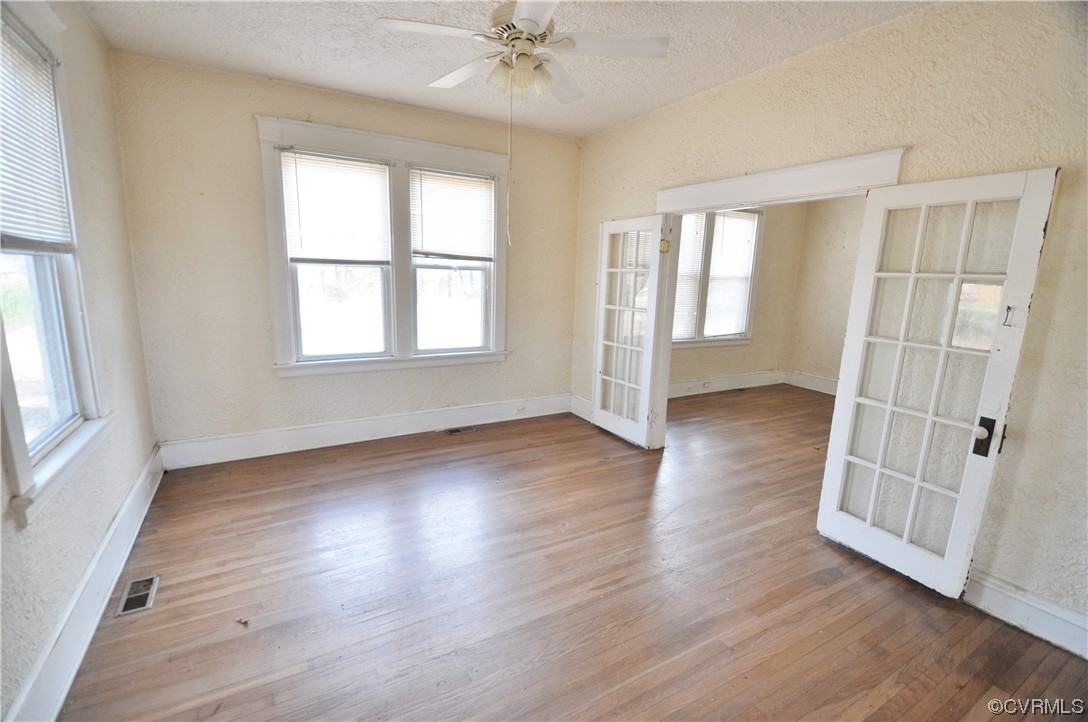 5301 Penick Road Richmond, VA 23228 - Photo 2 of 11 an empty room with wooden floor and windows