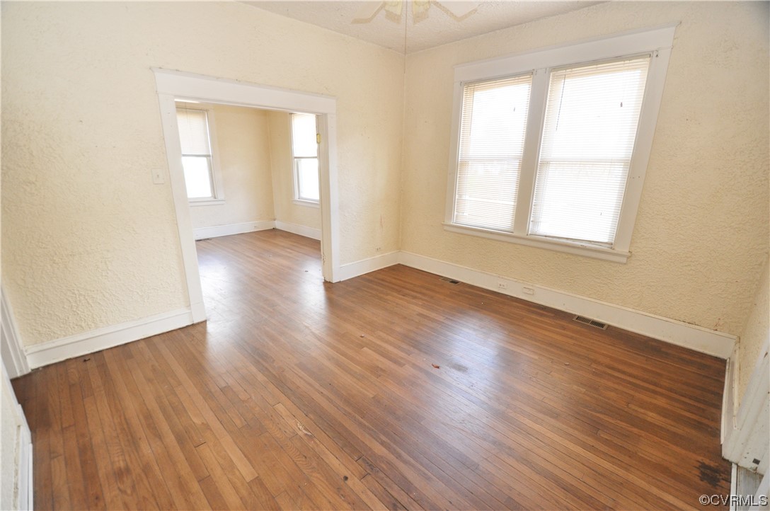 5301 Penick Road Richmond, VA 23228 - Photo 4 of 11 an empty room with wooden floor and windows
