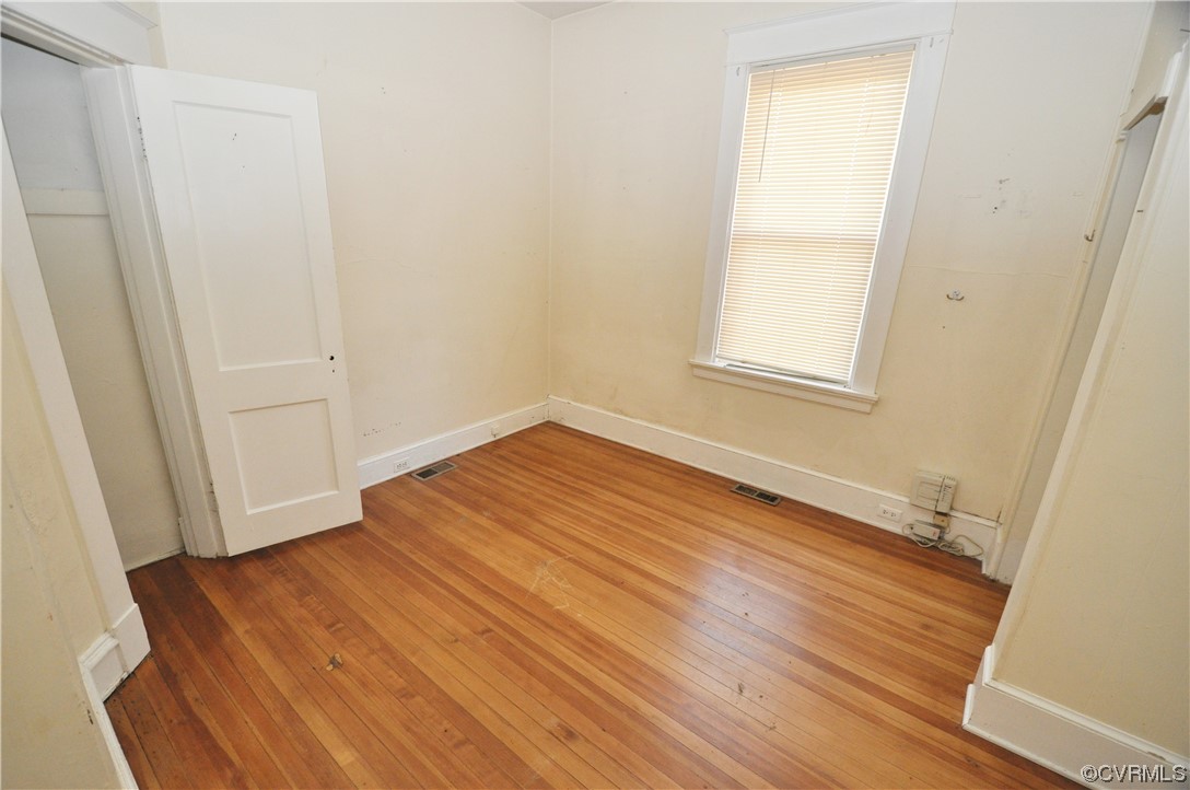 5301 Penick Road Richmond, VA 23228 - Photo 8 of 11 an empty room with wooden floor and windows