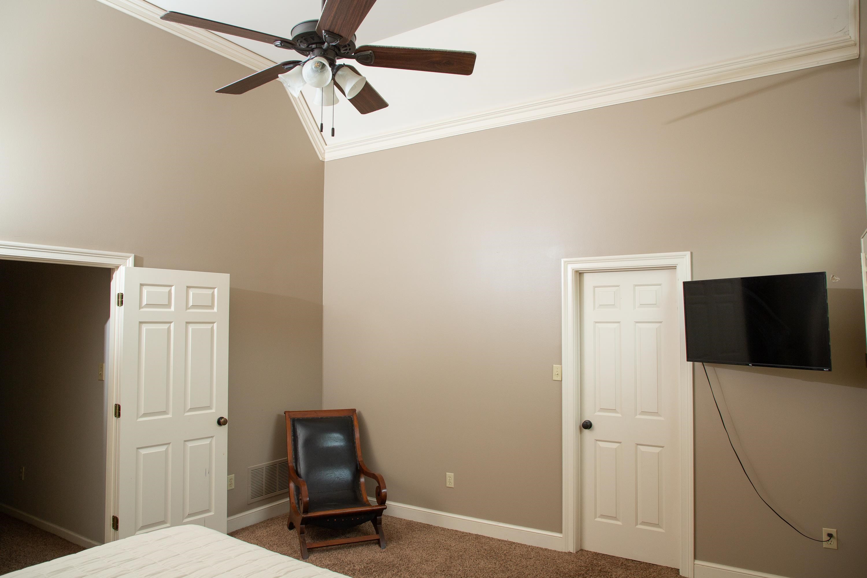10060 Avent Ridge Cove Collierville, TN 38017 - Photo 11 of 40 a bedroom with a bed and a chandelier