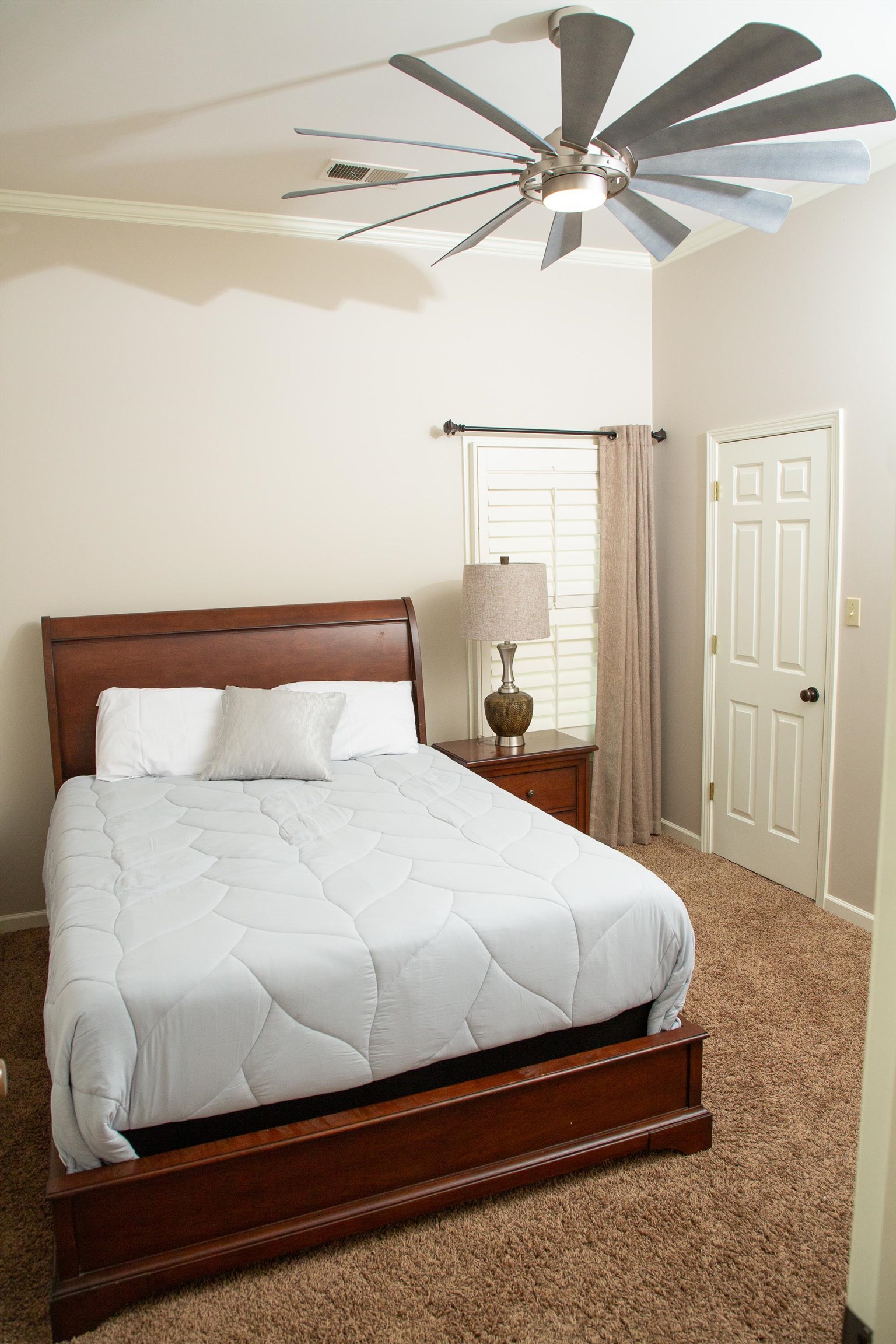 10060 Avent Ridge Cove Collierville, TN 38017 - Photo 12 of 40 a bedroom with a bed and a ceiling fan