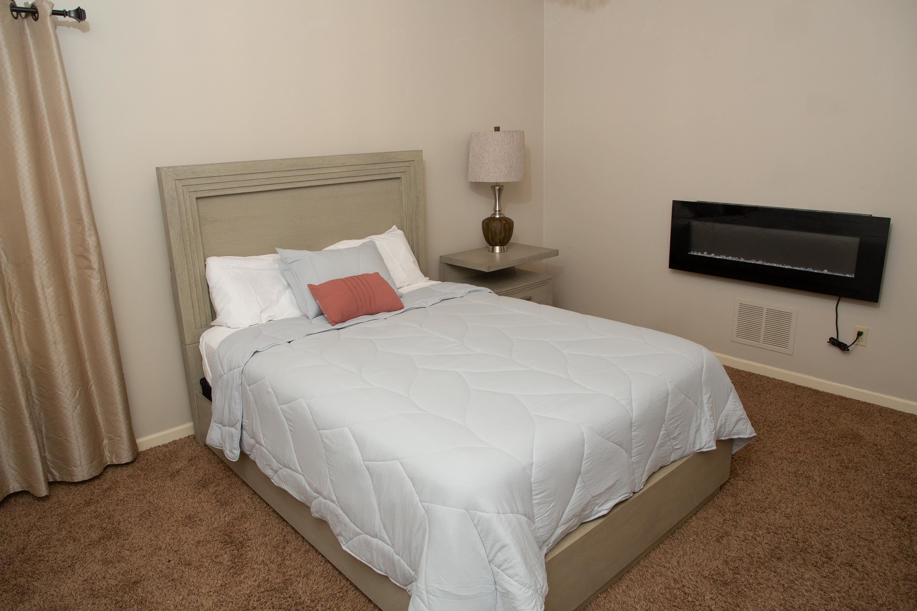 10060 Avent Ridge Cove Collierville, TN 38017 - Photo 13 of 40 a bedroom with a bed and a flat screen tv