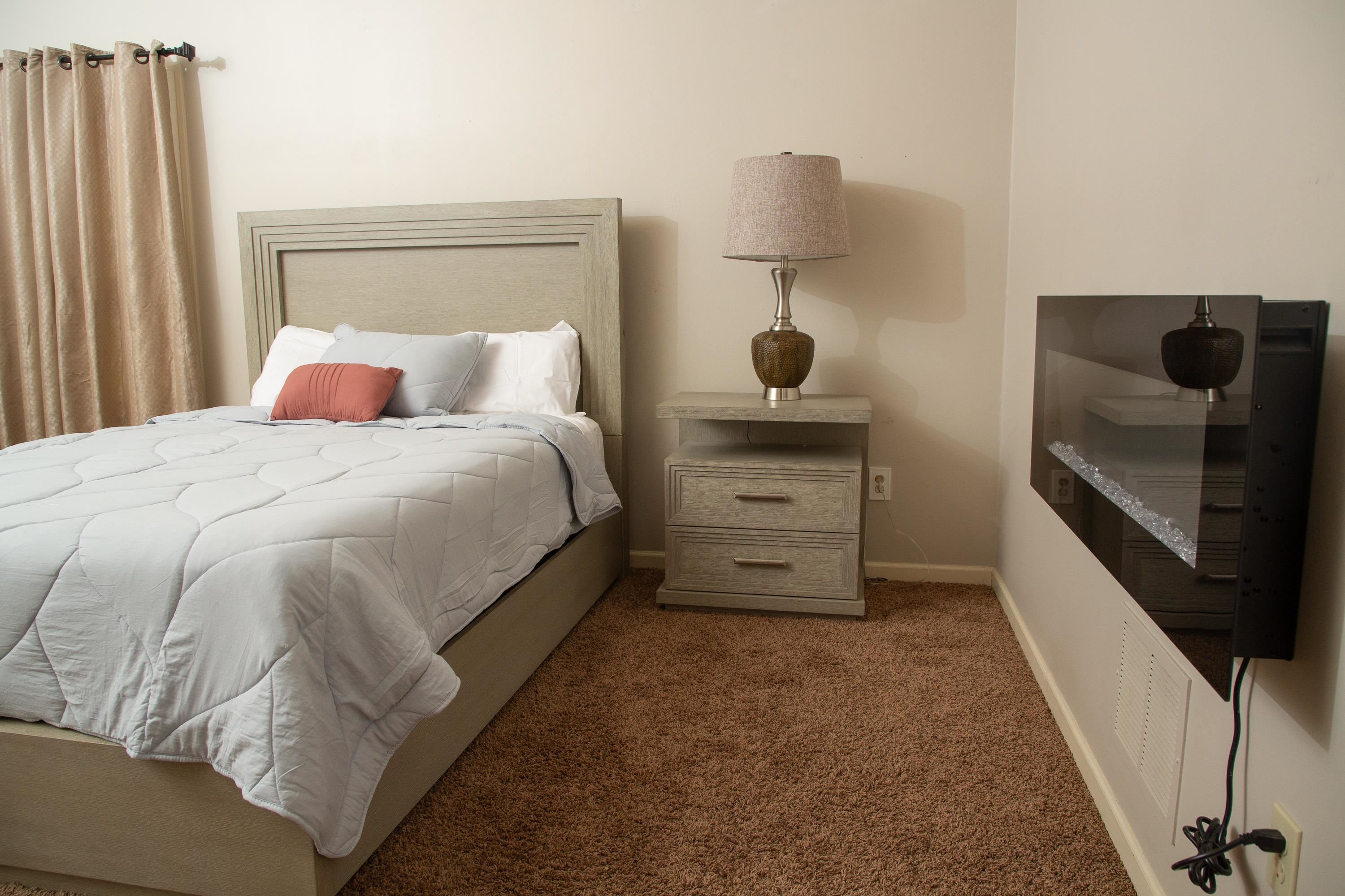 10060 Avent Ridge Cove Collierville, TN 38017 - Photo 14 of 40 a bedroom with a bed and a night stand