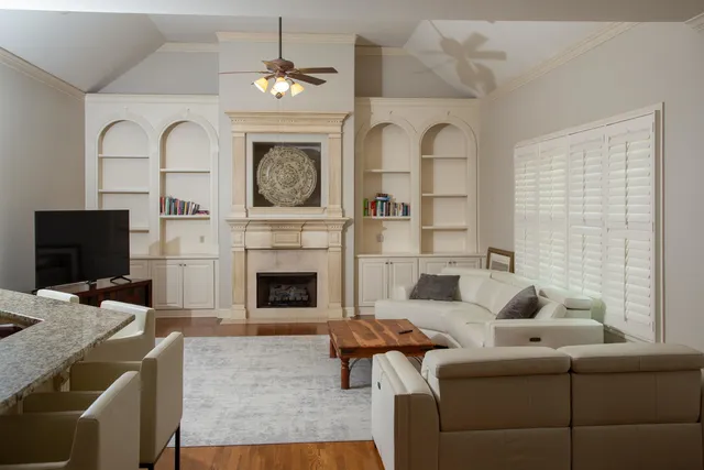 a living room with furniture a fireplace and a flat screen tv