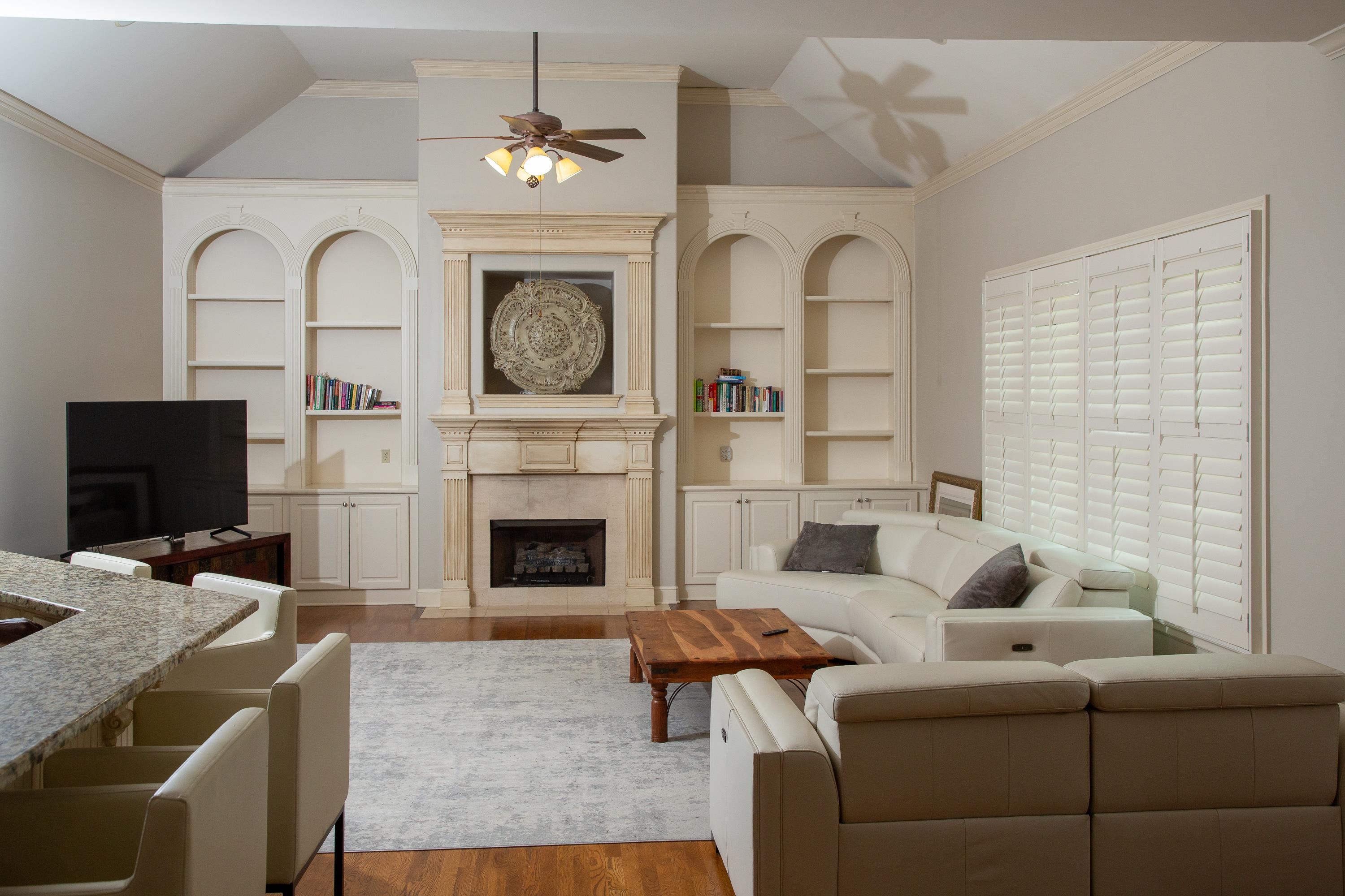 10060 Avent Ridge Cove Collierville, TN 38017 - Photo 16 of 40 a living room with furniture a fireplace and a flat screen tv