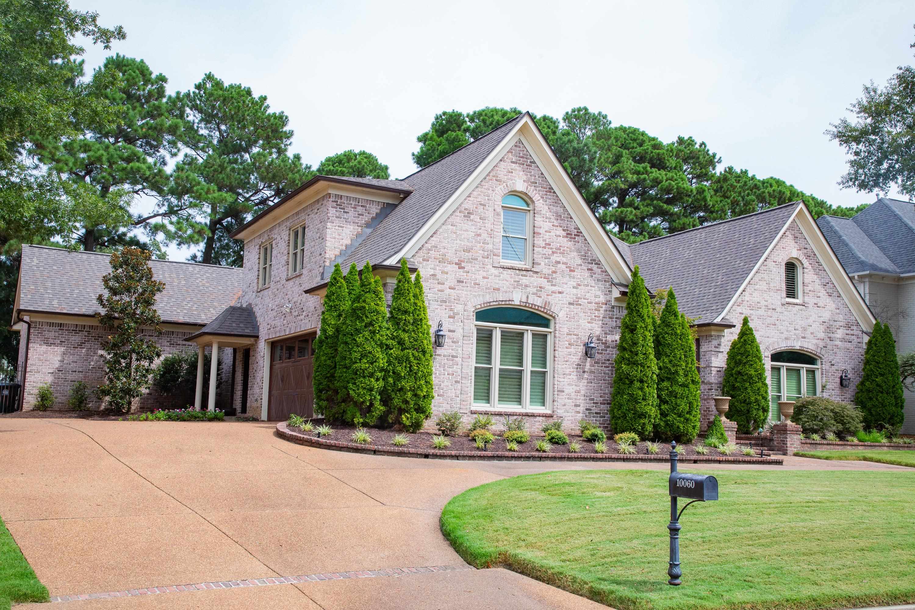 10060 Avent Ridge Cove Collierville, TN 38017 - Photo 2 of 40 a front view of a house with a yard