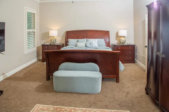 a bedroom with a bed and a lamp