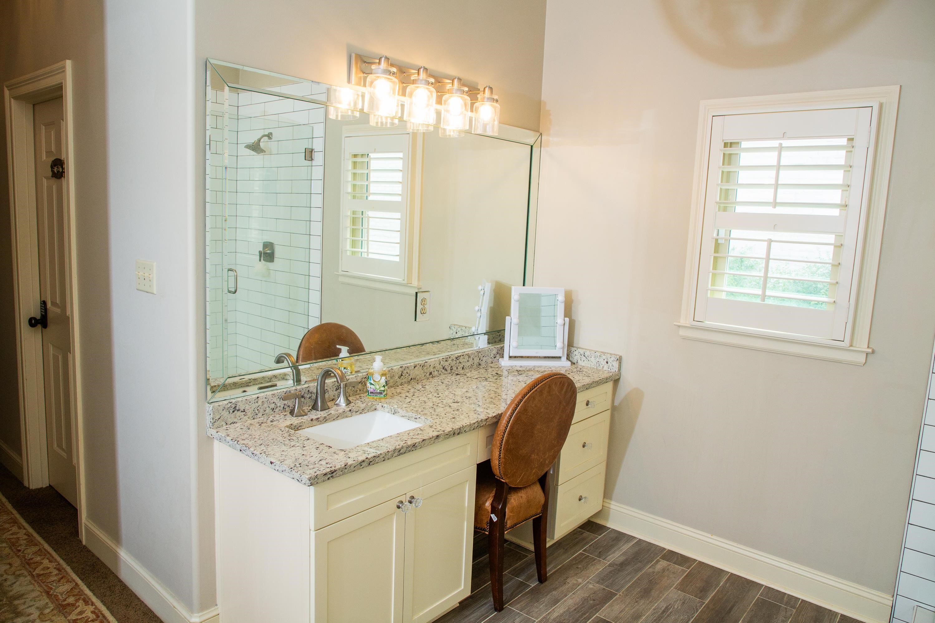 10060 Avent Ridge Cove Collierville, TN 38017 - Photo 38 of 40 a bathroom with a granite countertop sink a mirror and a shower
