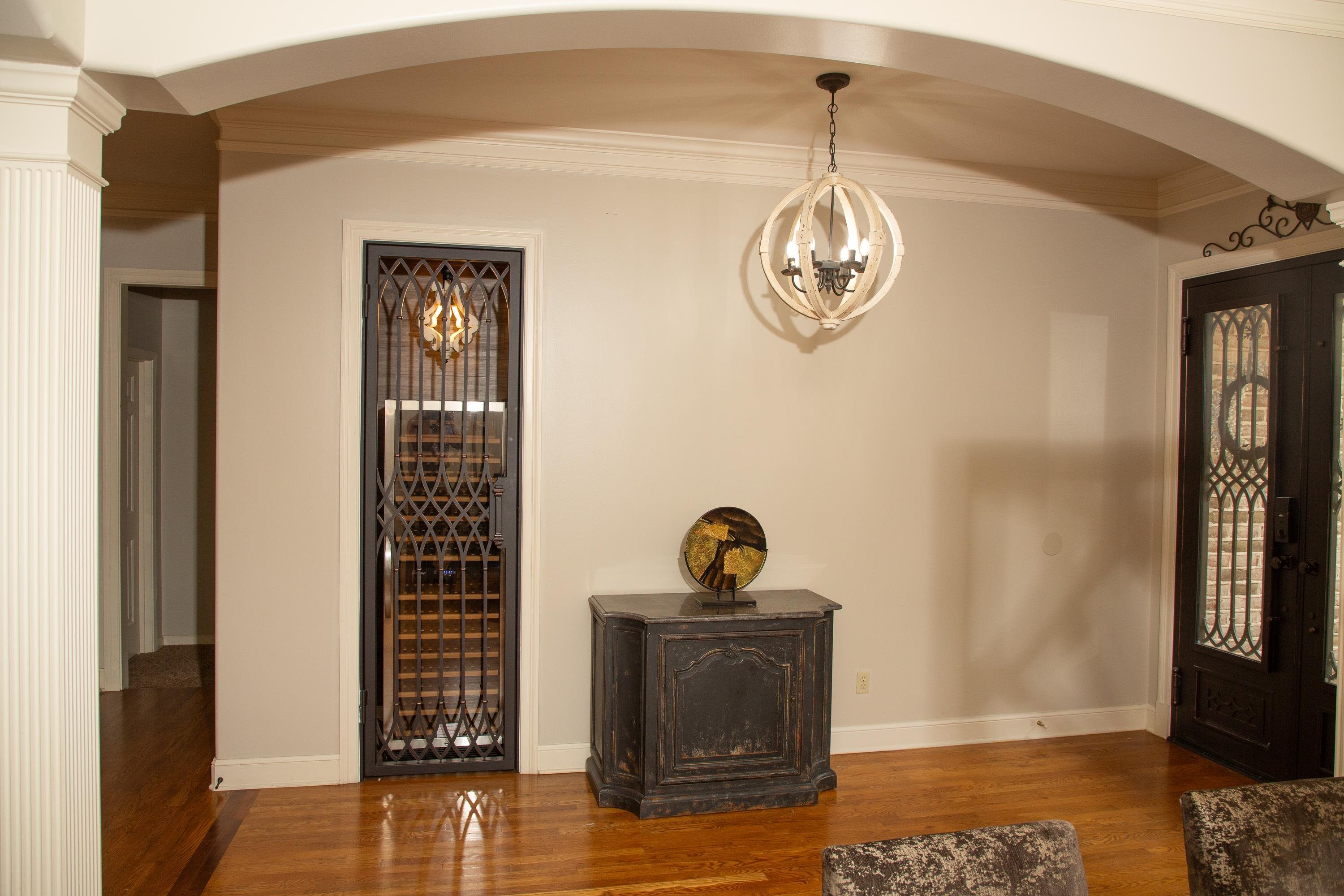 10060 Avent Ridge Cove Collierville, TN 38017 - Photo 6 of 40 a view of a hallway with wooden floor and a chandelier