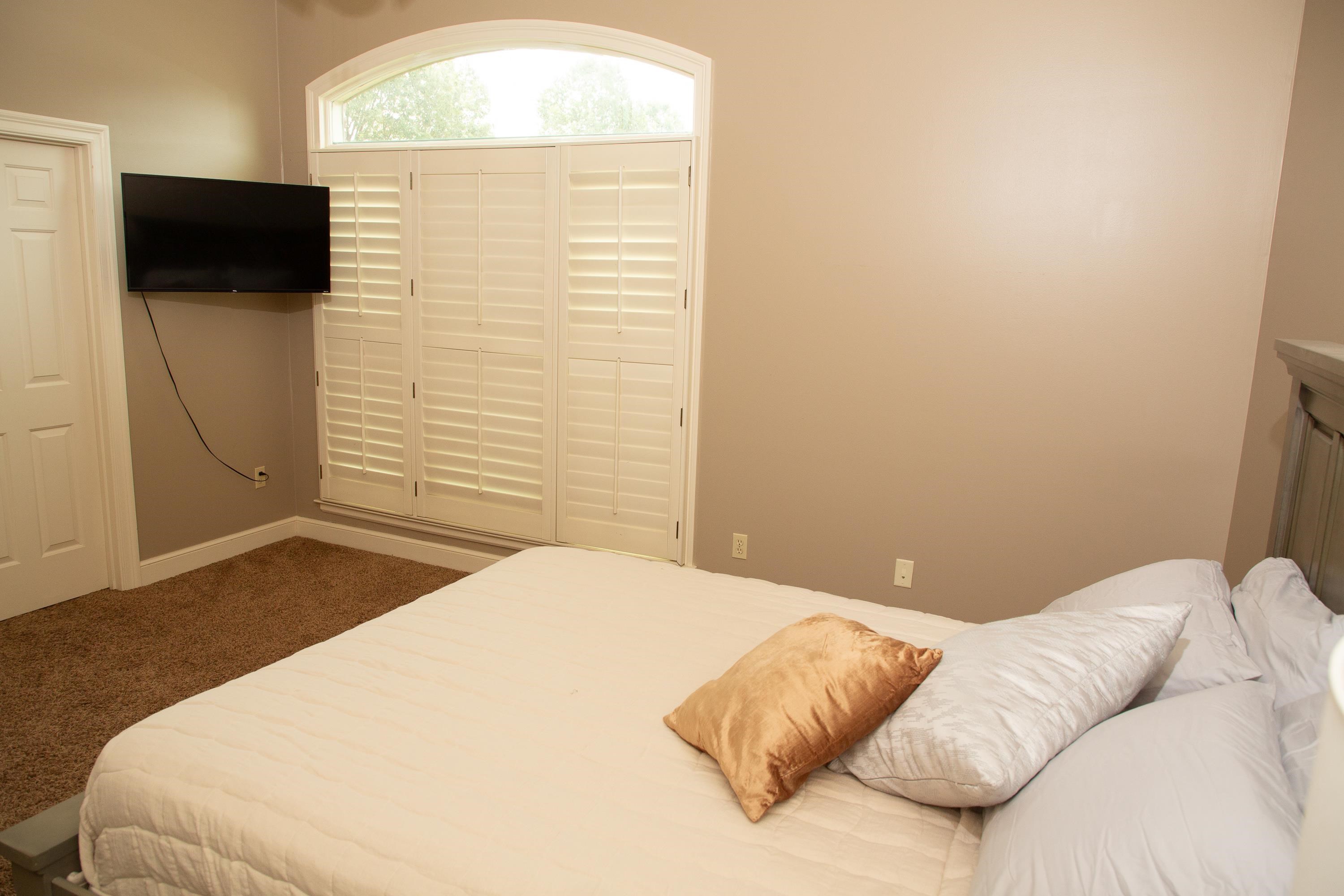 10060 Avent Ridge Cove Collierville, TN 38017 - Photo 10 of 40 a bedroom with a bed and a flat screen tv