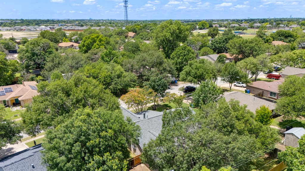 1502 Quail Run Road Pflugerville, TX 78660 - Photo 34 of 37 An aerial perspective reveals a harmonious community nestled amidst a verdant canopy.