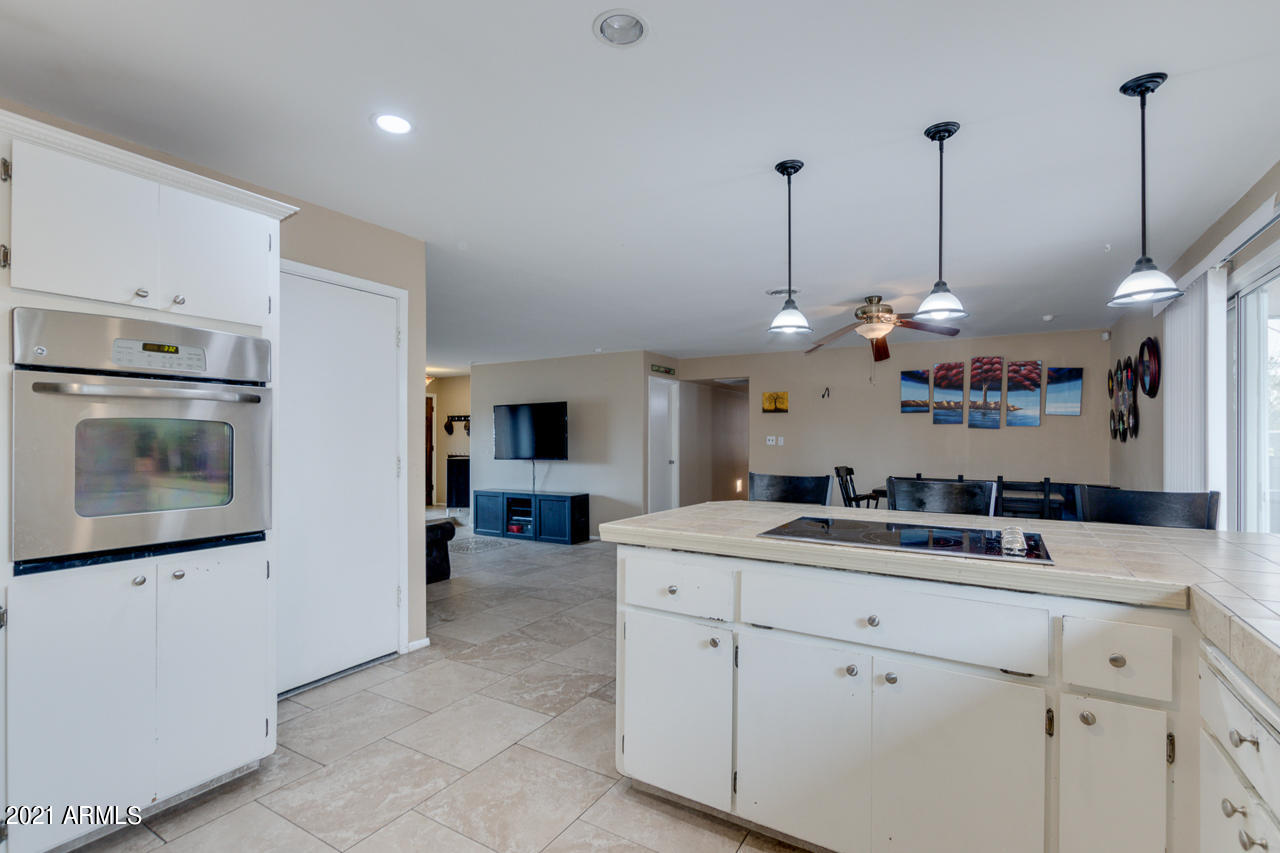 4215 West Dailey Street Phoenix, AZ 85053 - Photo 15 of 32 a view of a kitchen with a sink and dishwasher a refrigerator with white cabinets