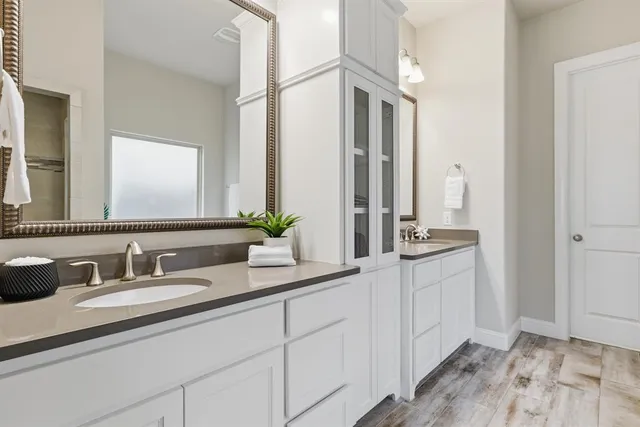 a bathroom with a tub sink and mirror