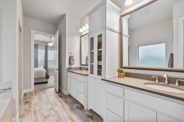 a bathroom with a sink double vanity and a mirror