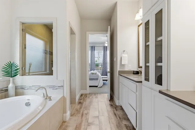 a bathroom with a double vanity sink and a mirror