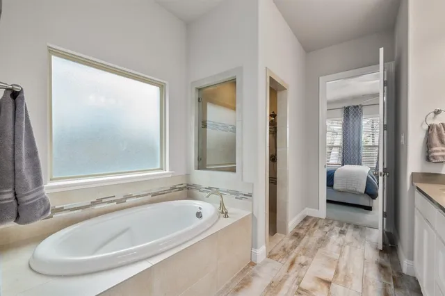 a en suite bathroom with a tub and mirror