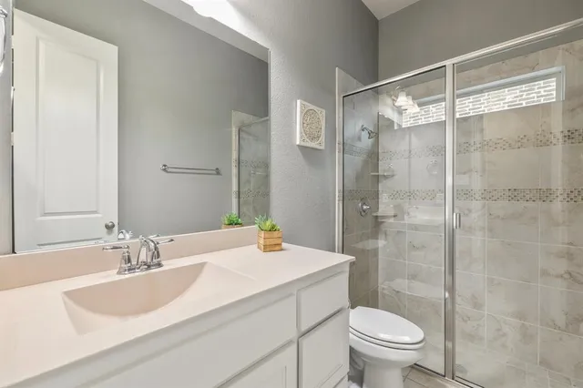 a bathroom with a sink toilet and shower