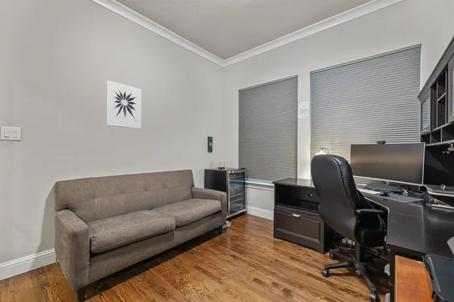 a living room with furniture a piano and a flat screen tv