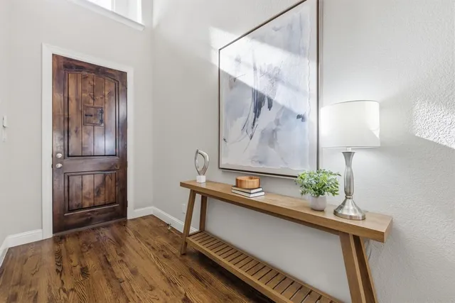 a room with wooden floor and mirror