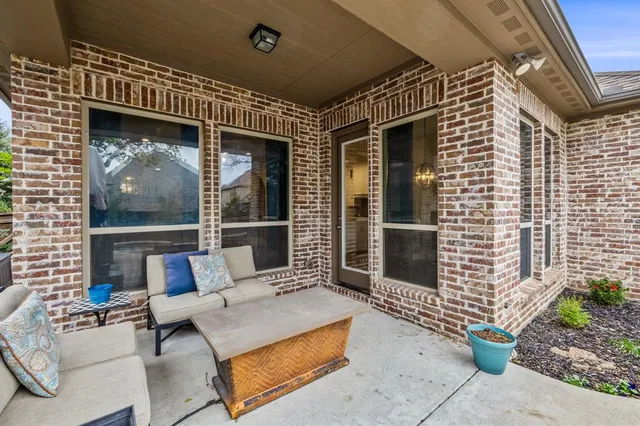a building outdoor space with patio furniture and potted plants