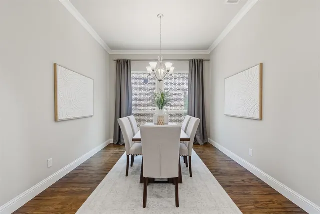 a dining room with furniture a chandelier and wooden floor
