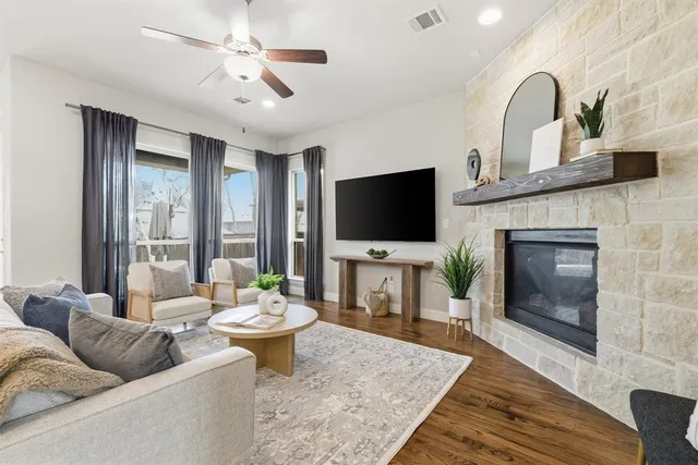 a living room with furniture a fireplace and a flat screen tv