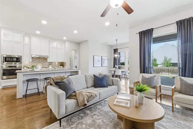 a living room with furniture kitchen and a table