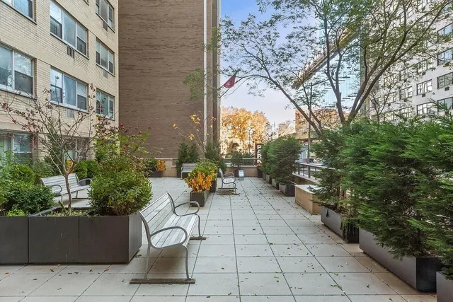a view of a patio with table and chairs and potted plants