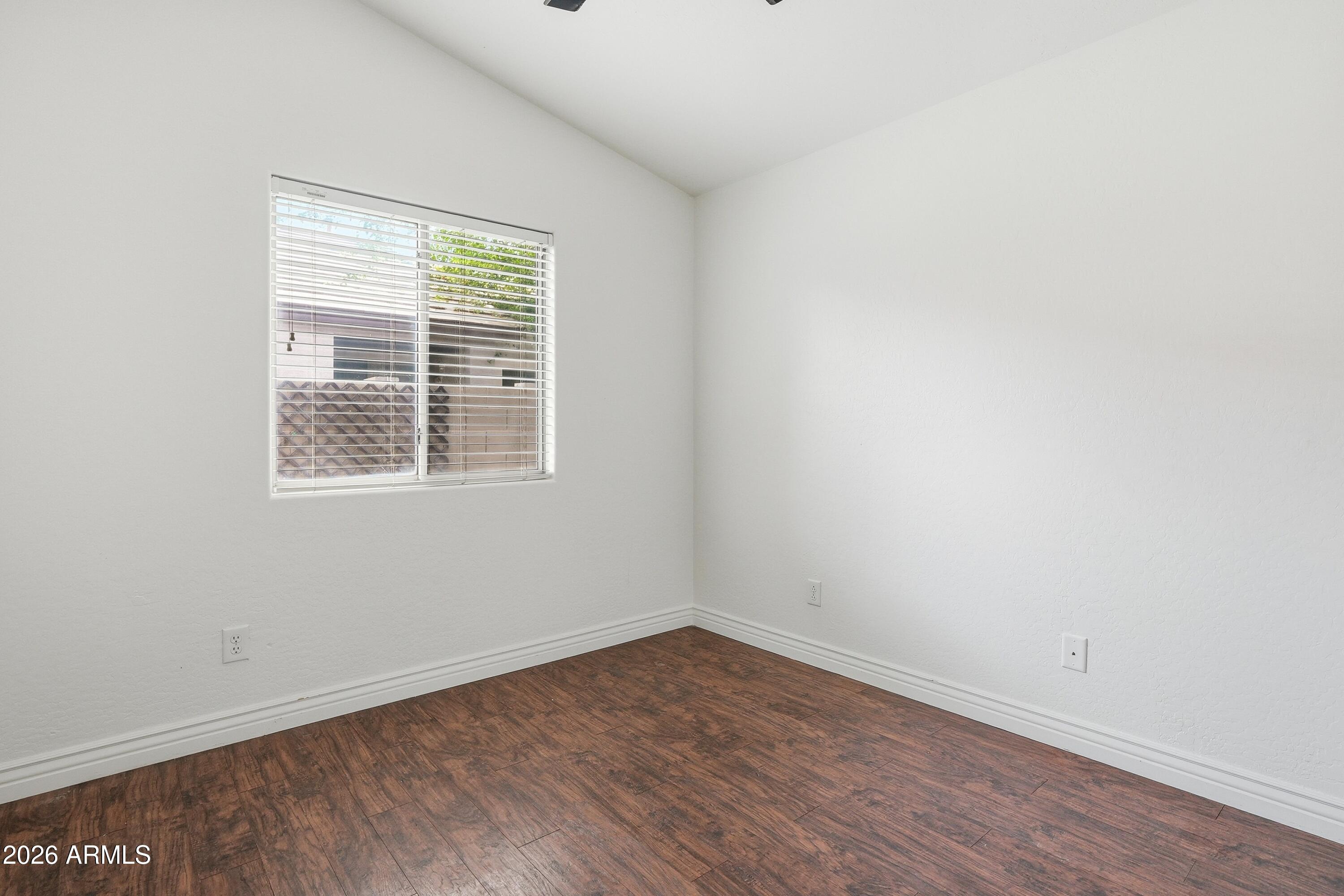 3242 East Bonanza Road Gilbert, AZ 85297 - Photo 17 of 36 wooden floor in an empty room with a window