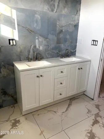 a bathroom with a sink and vanity