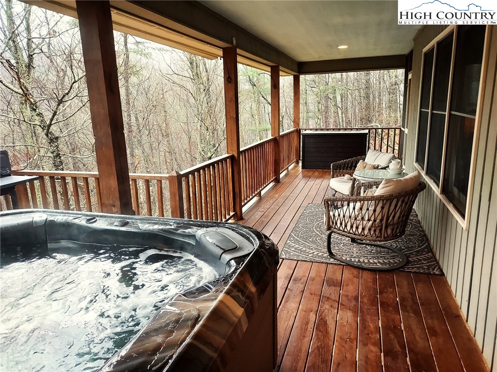 247 Hawkbill Road Ferguson, NC 28624 - Photo 10 of 25 a view of balcony with wooden floor and seating space